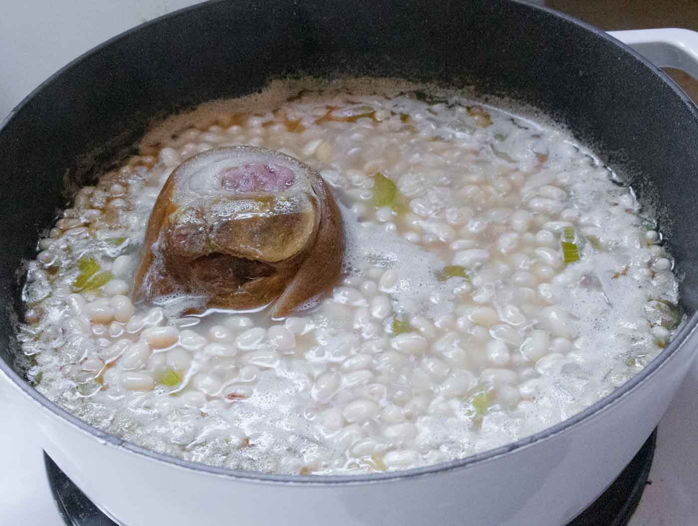 A photo showing the soup cooking down, and needing more water to cover the beans.
