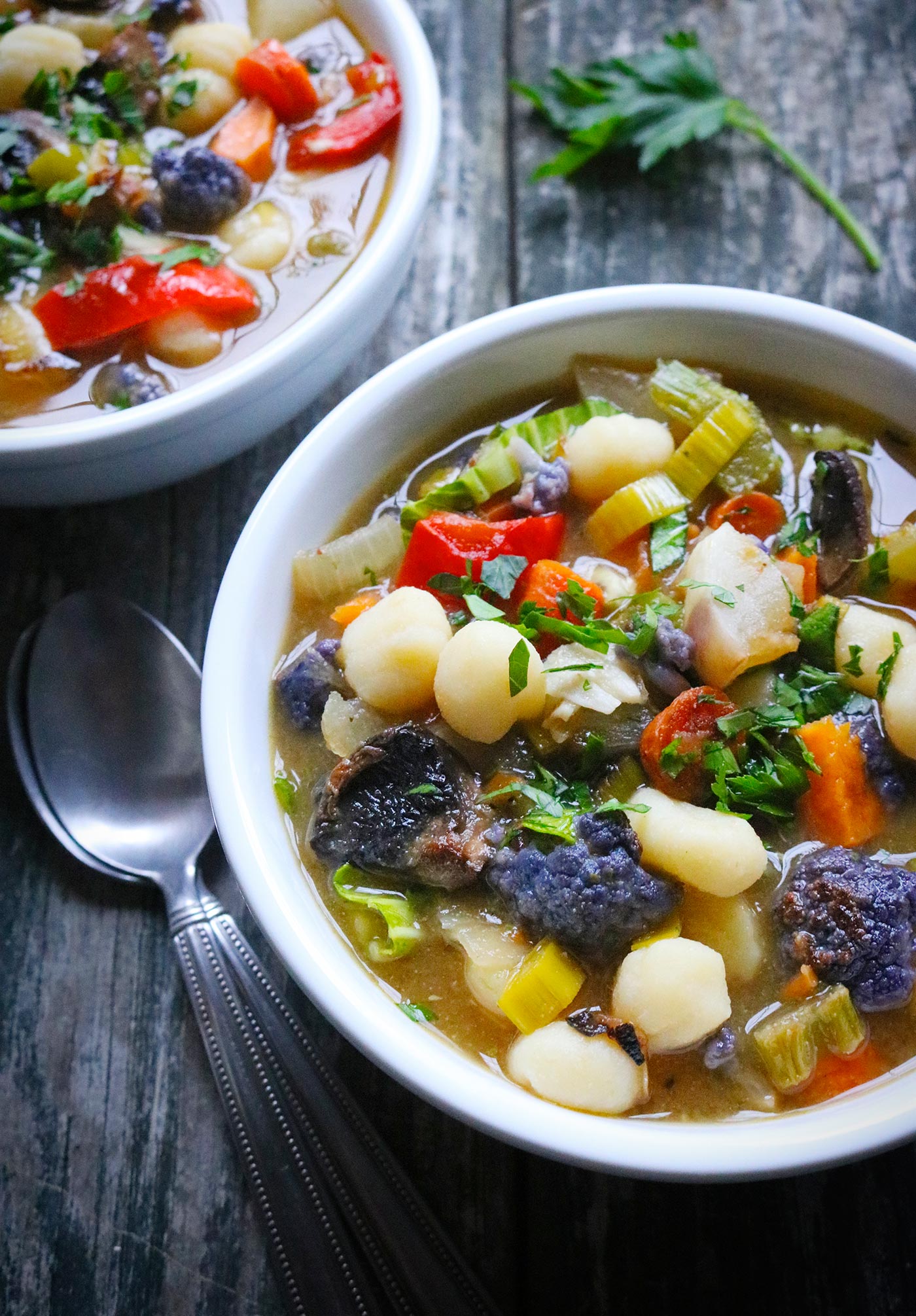 Angled view of two bowls of Sheet Pan Roasted Vegetable Soup.