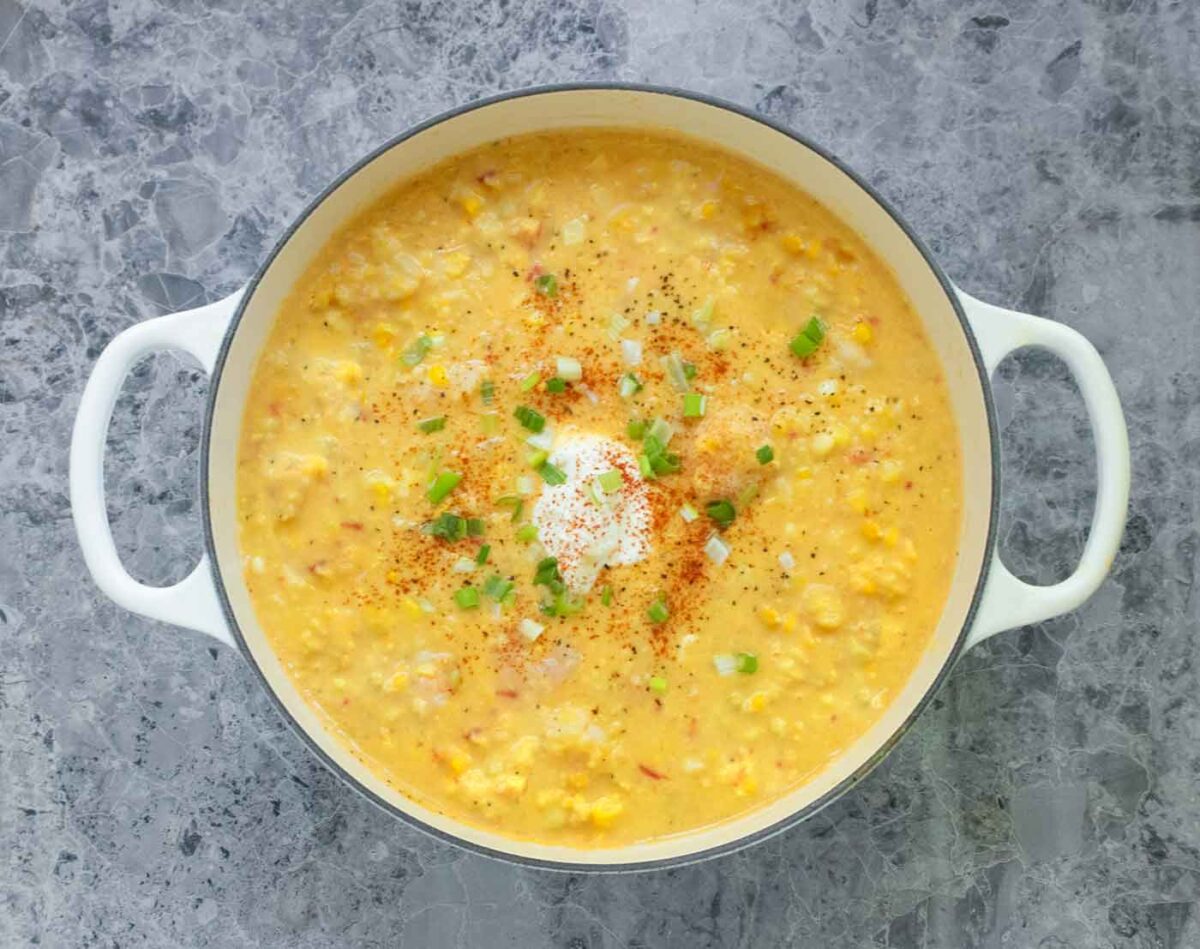 Overhead view of Shrimp and Corn Chowder in a white Dutch oven.