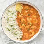 Shrimp Etouffee with rice in a large white Dutch oven.