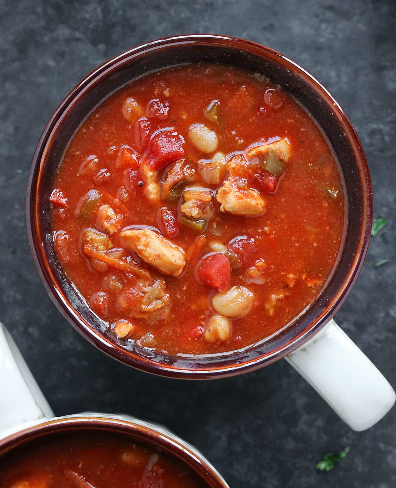 Overhead view of a bowl of Game Day Slow Cooker BBQ Chicken Soup.