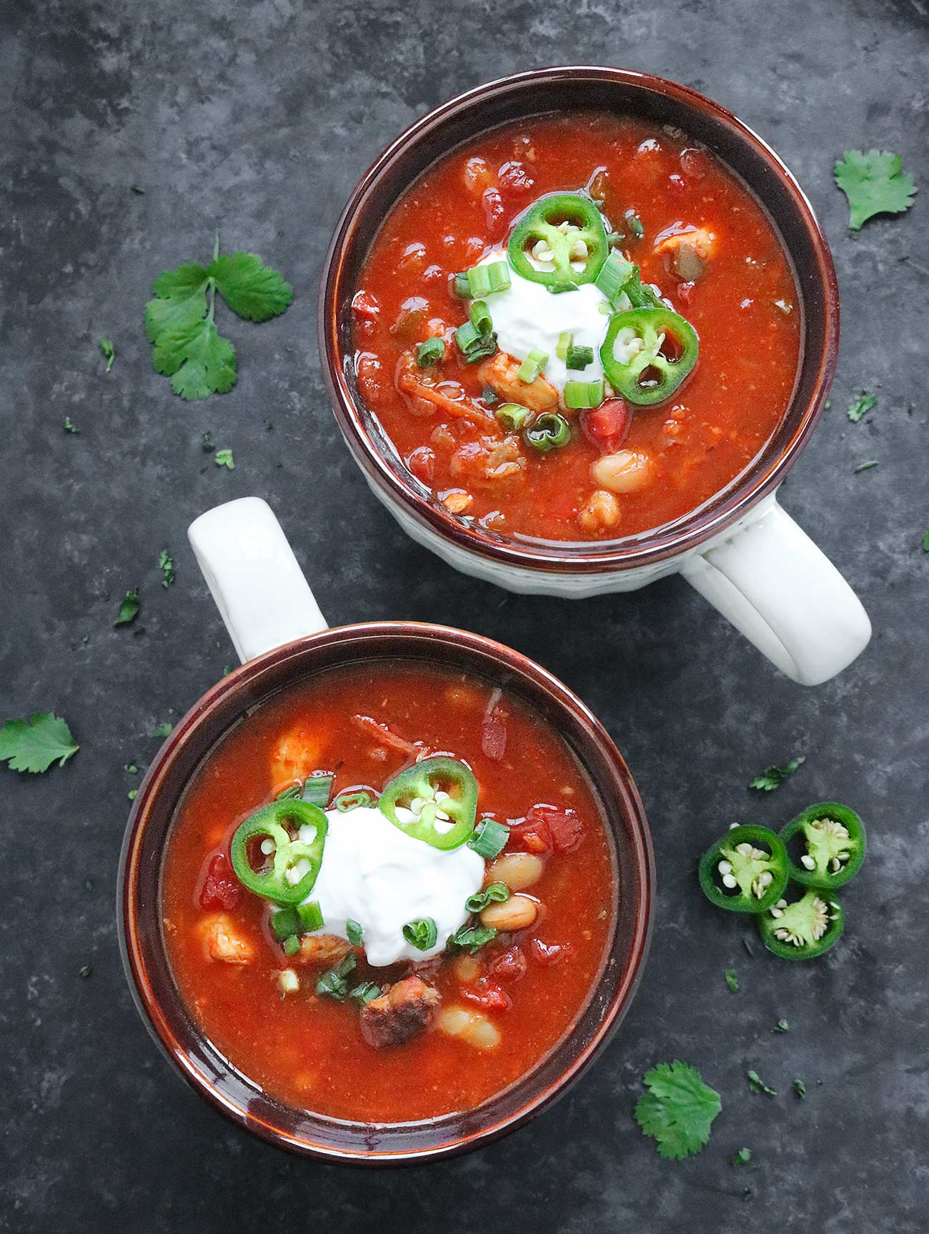 Overhead view of two bowls of Game Day Slow Cooker BBQ Chicken Soup.