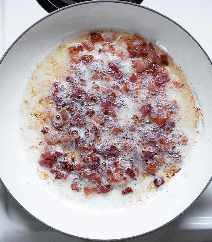 Bacon cooking in the pot.