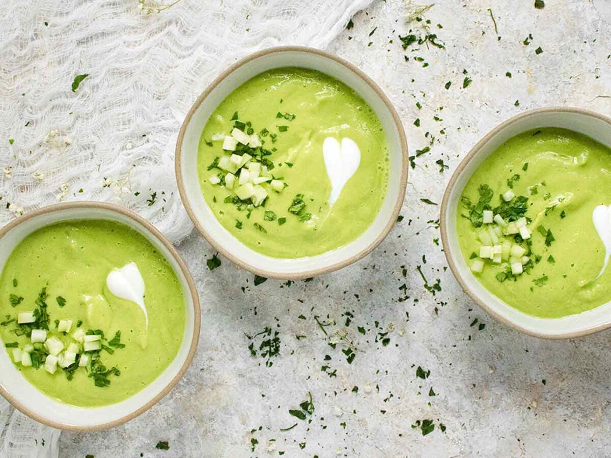 Overhead view of three bowls of Spicy Green Goddess Gazpacho.