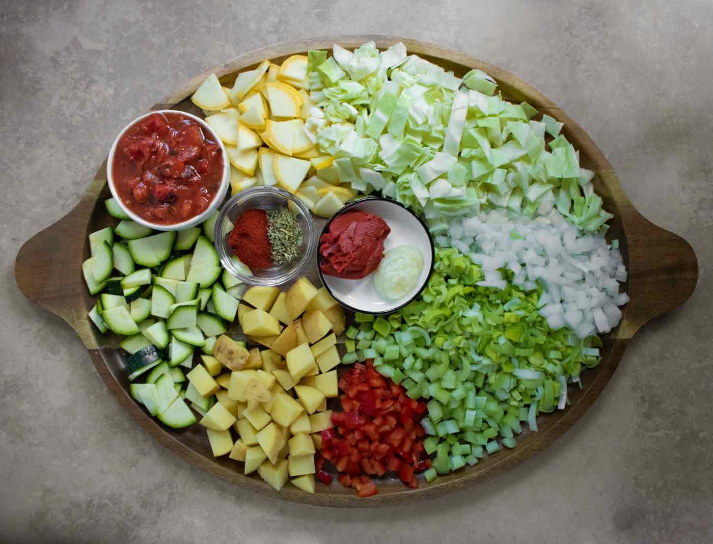 Cabbage Soup ingredients arranged on a wooden platter.