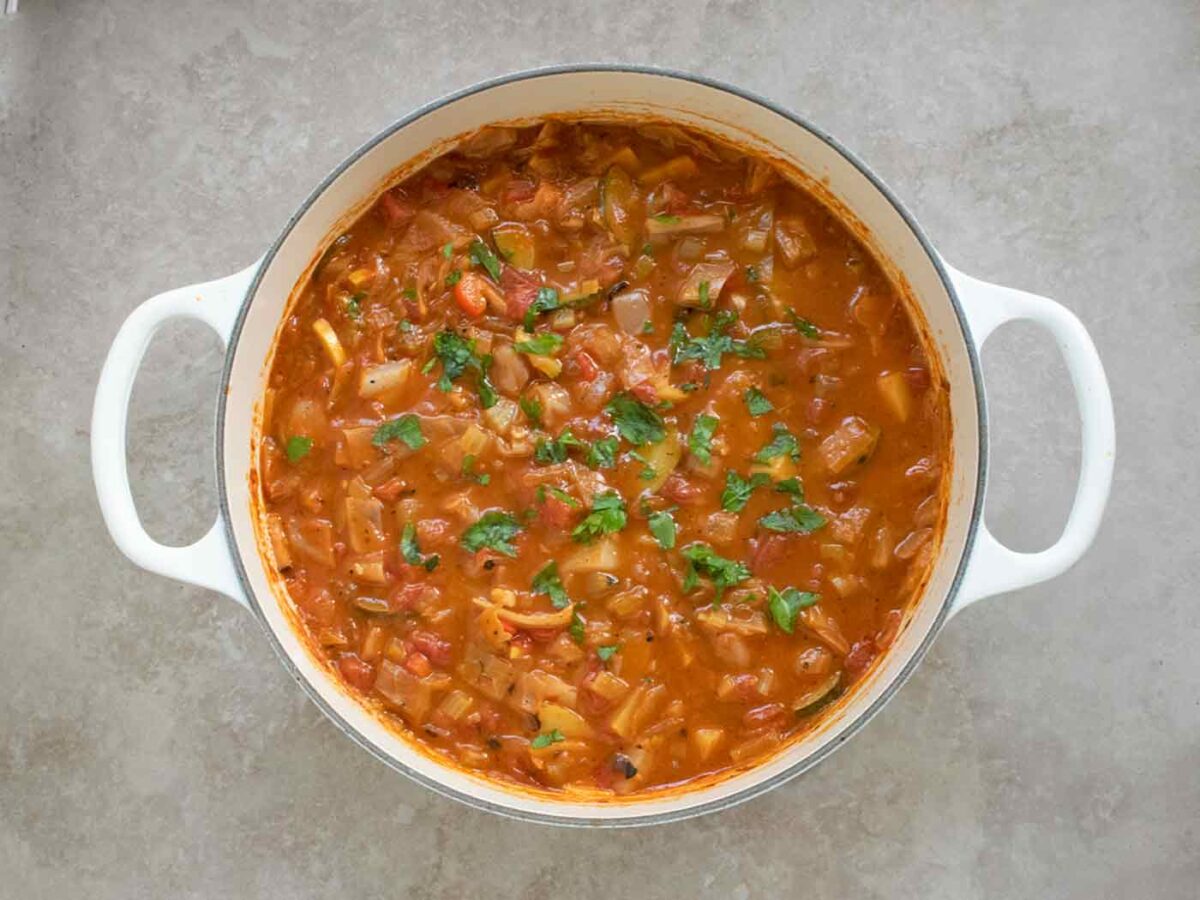 Summer Cabbage Soup in a large white Dutch oven.