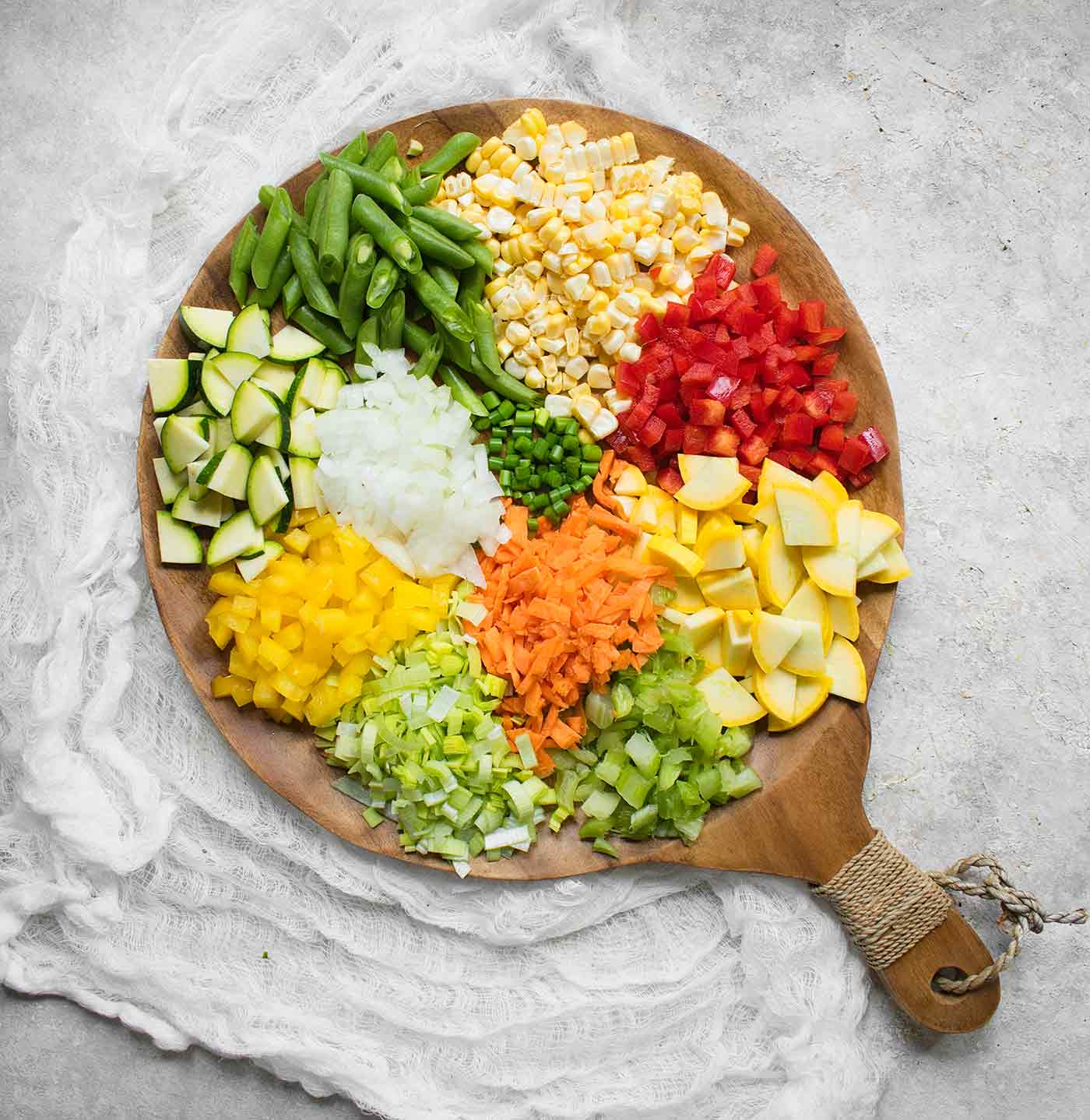 Ingredients for Summer Minestrone arranged on a serving board