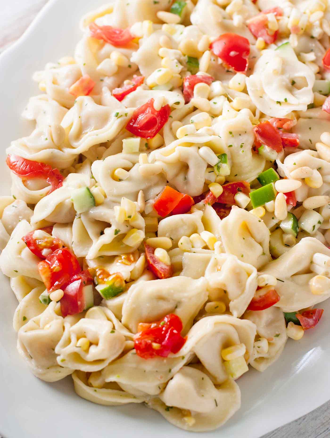 Close-up of Summer Tortellini Pasta on a white platter.