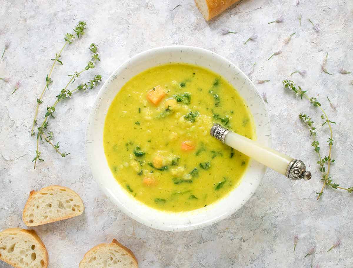 Sunshine Superfood Soup in a bowl with a spoon.