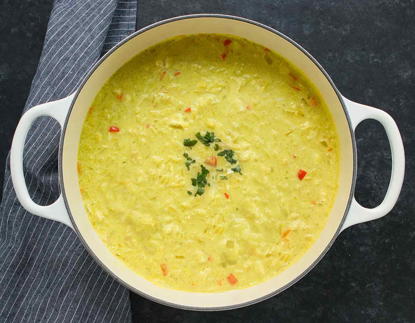 Thai Coconut Chicken Soup in a large white Dutch Oven