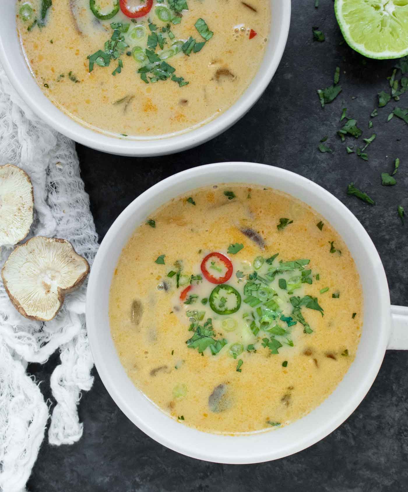 Overhead shot of two bowls of Thai coconut mushroom soup.