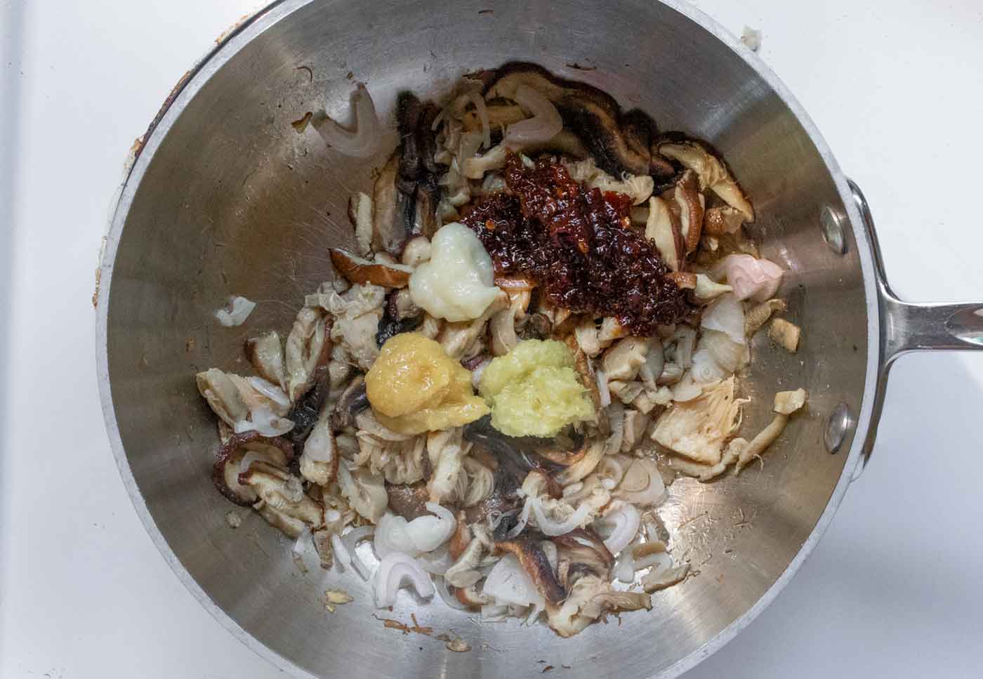Adding the seasonings to the mushrooms.