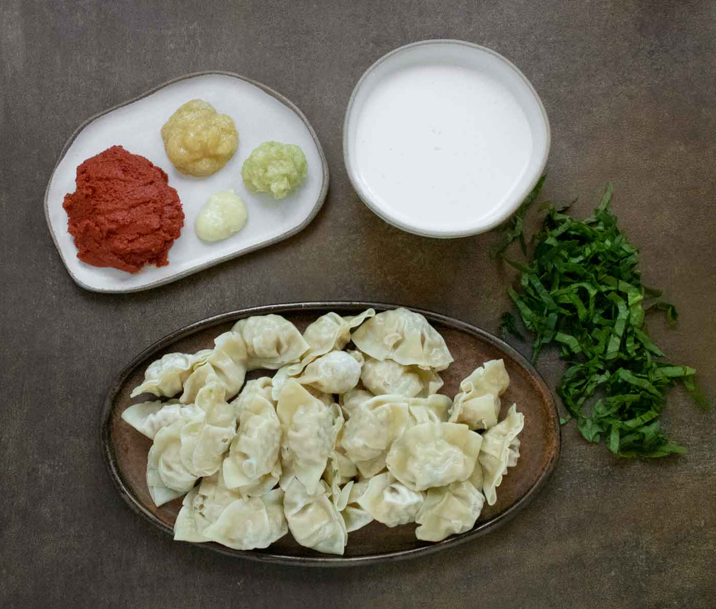 The main ingredients for Thai Red Curry Dumpling Soup on trays.