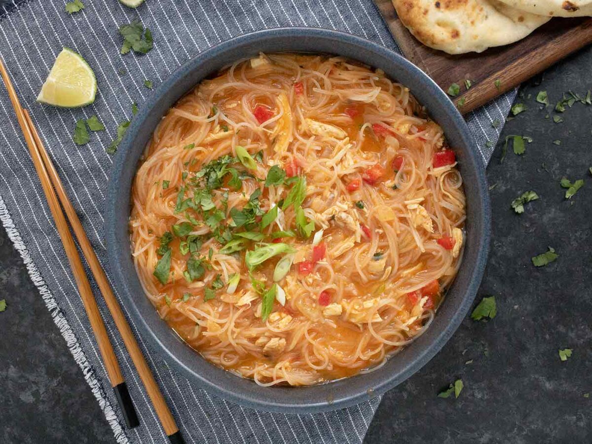 Overhead view of a bowl of Thai Red Curry Noodle Soup.