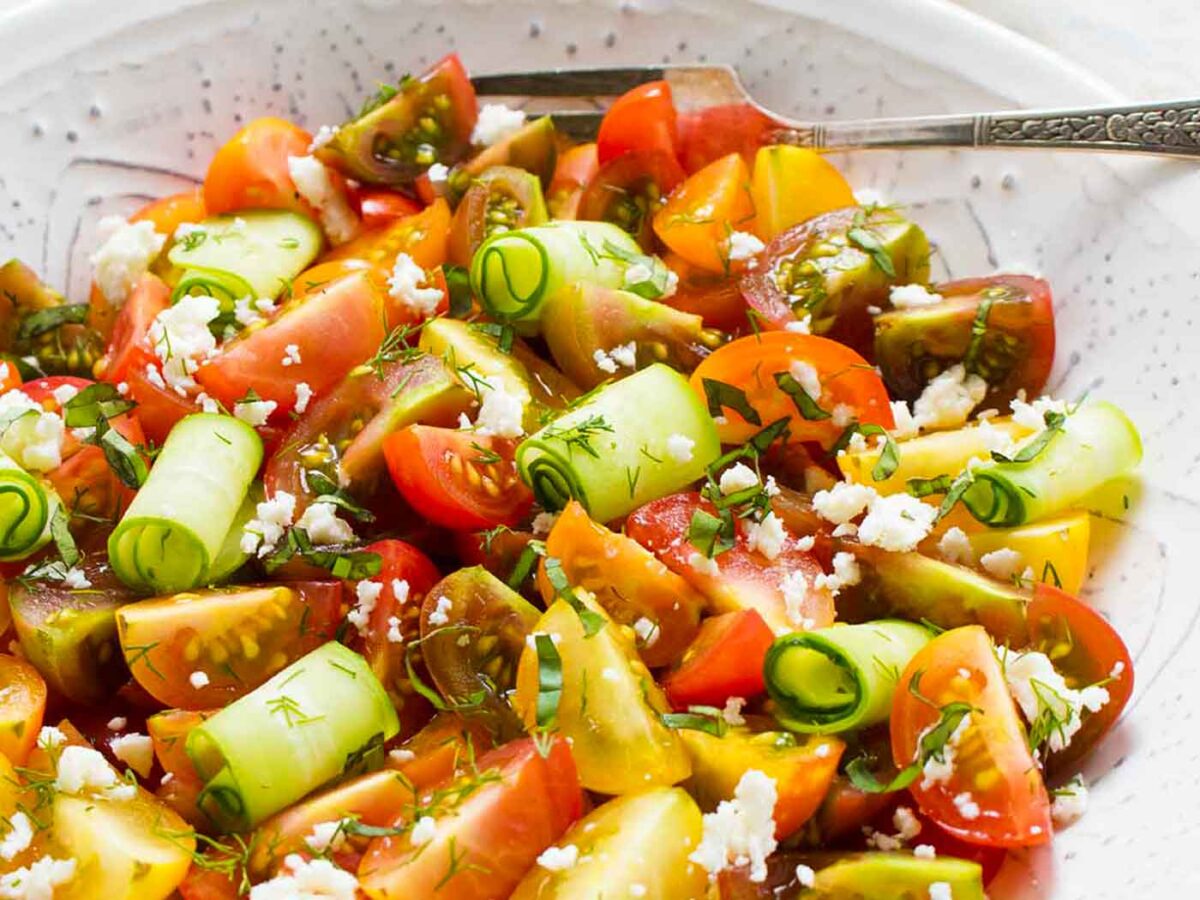 Tomato Lovers Tomato Salad in a white serving bowl with a fork.