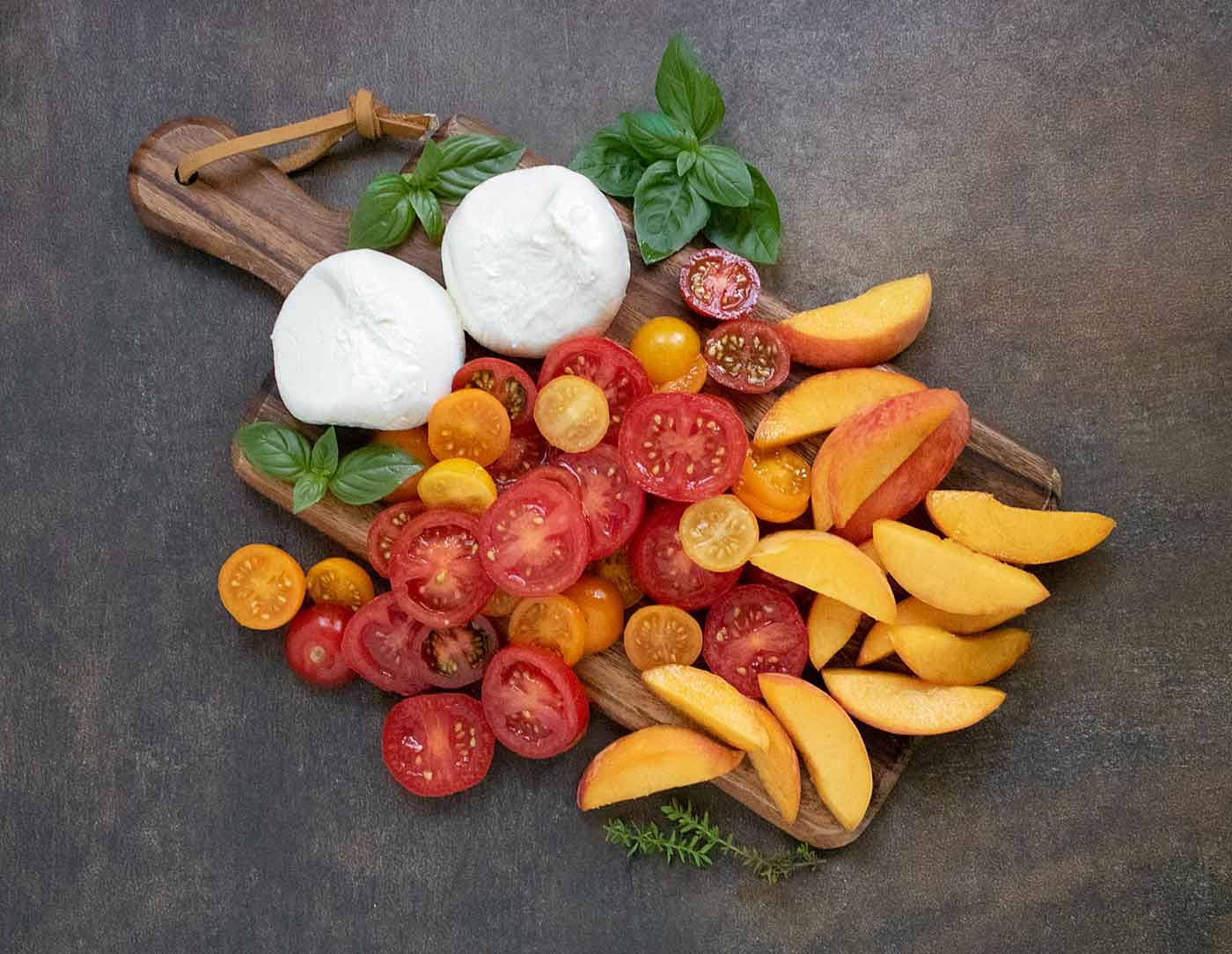 The salad's ingredients on a wooden serving board.