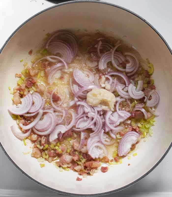 Adding shallots and garlic to the aromatics.