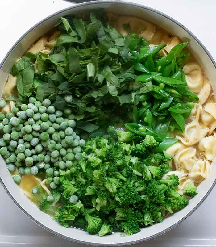 Green vegetables added to the soup.