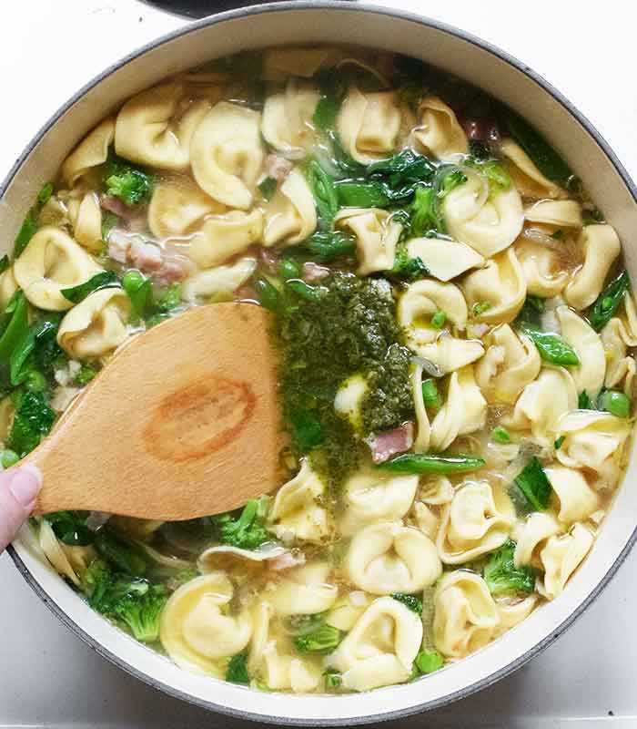 Finishing the soup with some pesto and champagne vinegar.