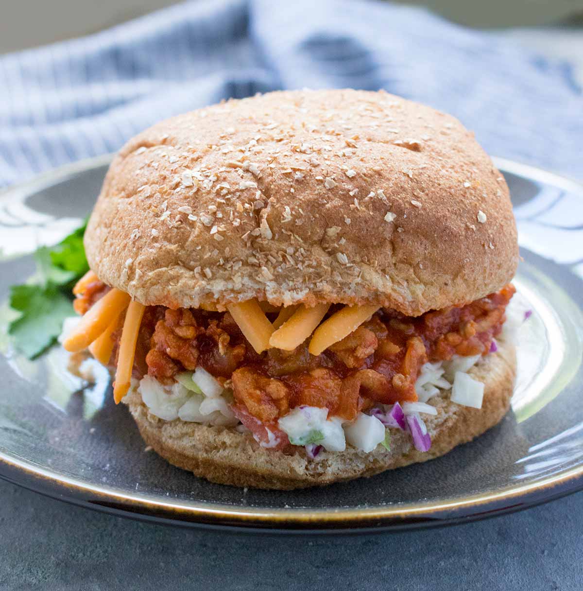 Turkey Sloppy Joes with cheese and slaw on a bun. Recipe at SoupAddict.com