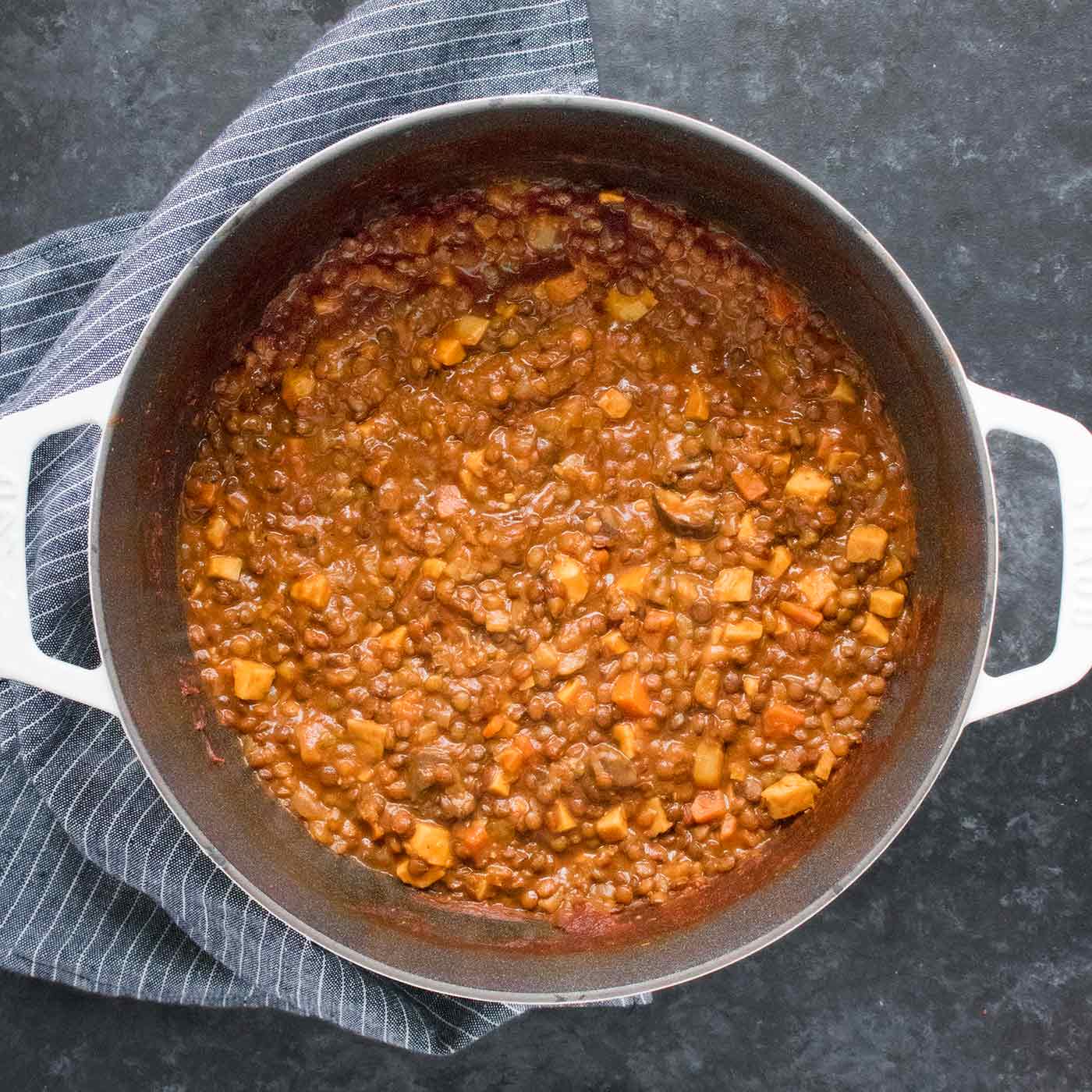 Vegan Irish Stew in a white Dutch oven, ready to serve