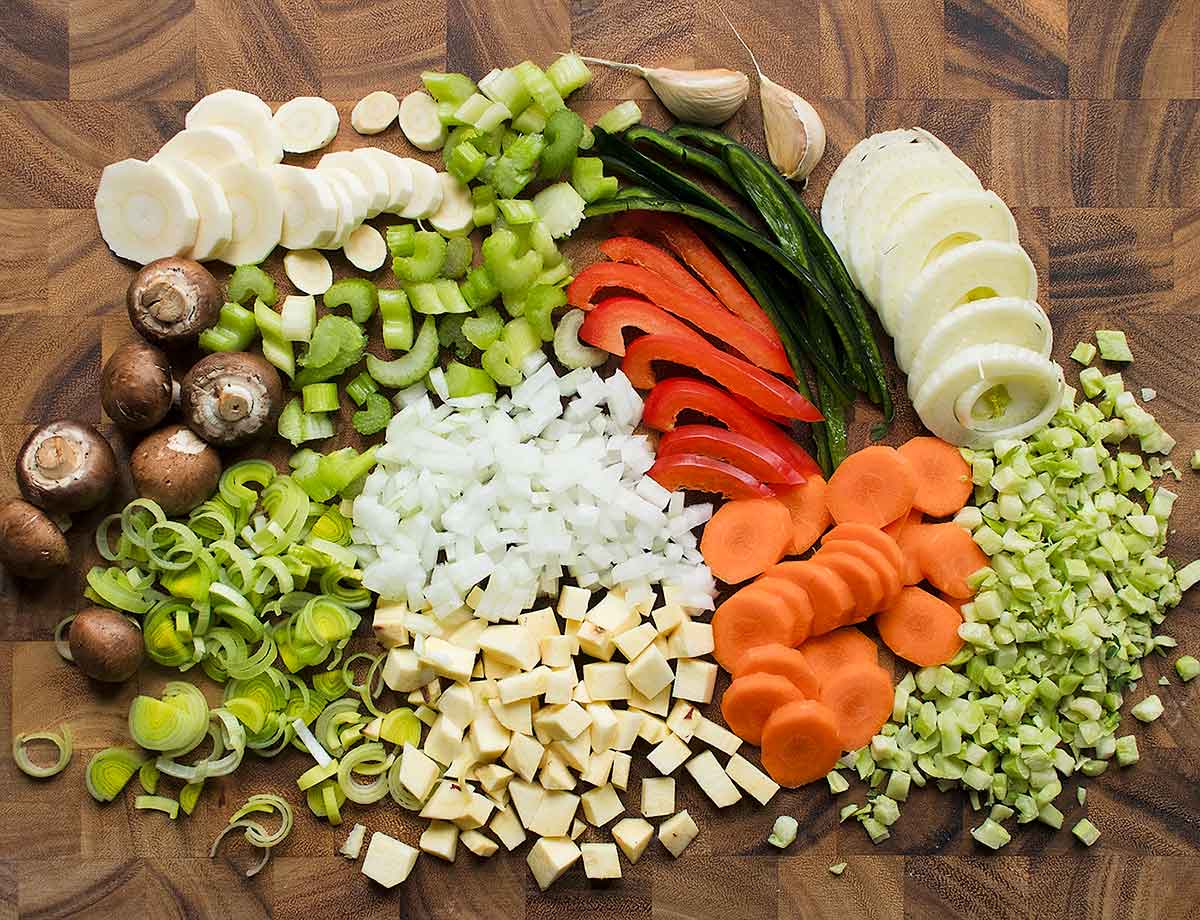 Chopped vegetables on cutting board for Vegetable Dumpling Soup.