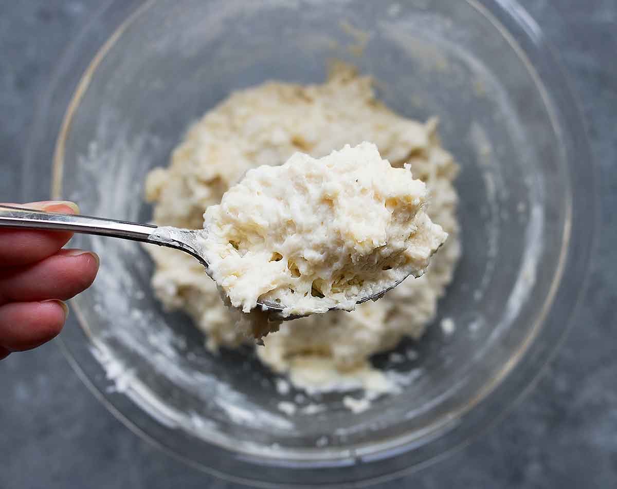 Vegan dumpling dough close-up on a spoon, for Vegetarian Dumpling Soup