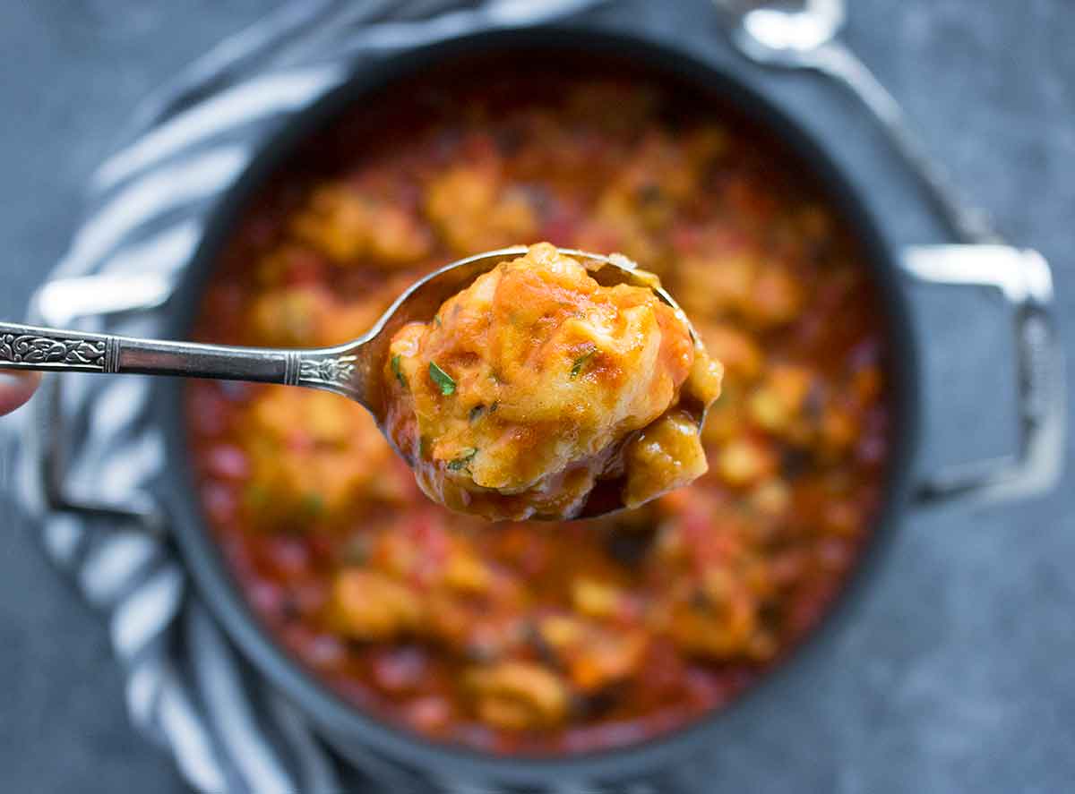 Close-up of spoonful of vegetable dumpling soup.