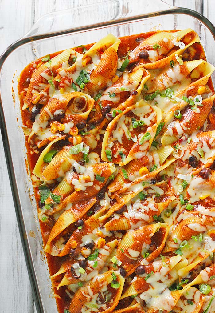 Enchilada stuffed pasta shells in a glass baking dish