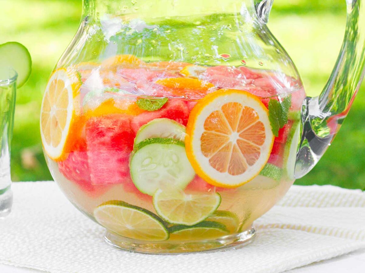 Close up view of a glass pitcher of Homemade Vitamin Water.