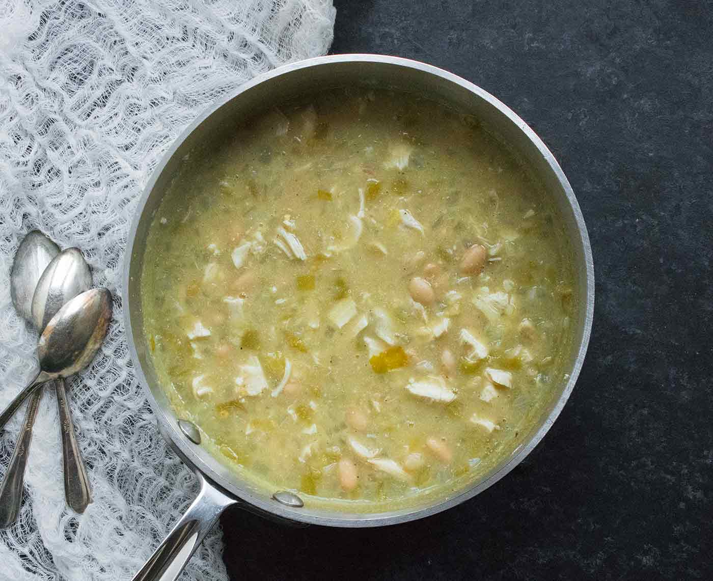 A pot of White Chicken Chili on a dark background