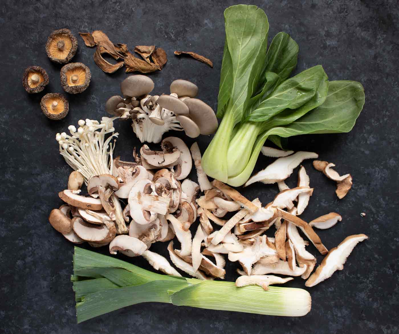 Soup ingredients spread out on a board.