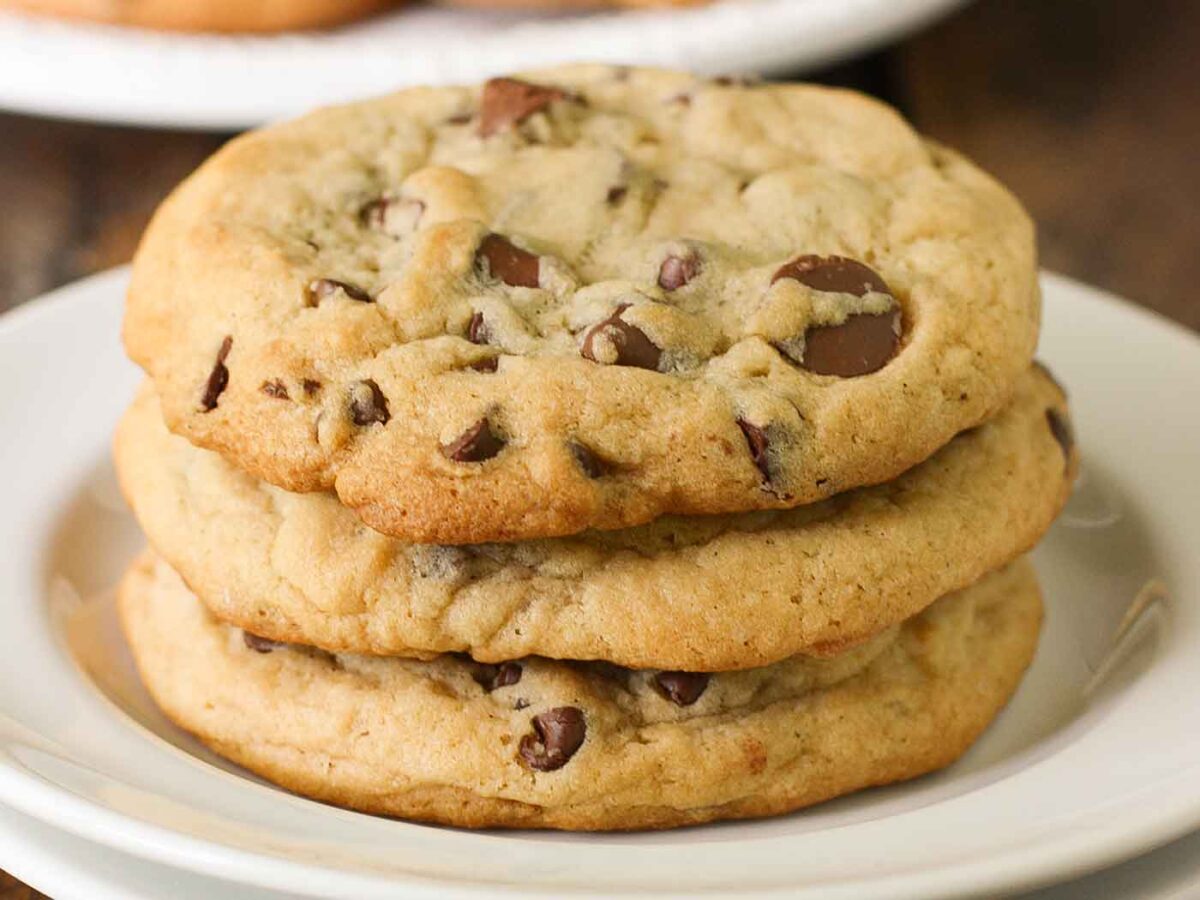 Three XXL Softbaked Chocolate Chip Cookies on a plate.